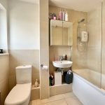 Modern bathroom with shower and sink.