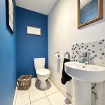 Small bathroom with blue and white decor.