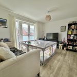 Modern living room with cot and toys.