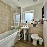 Modern bathroom with bathtub and sink.