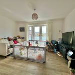 Family living room with toys and playpen.