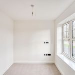 Empty white room with large window