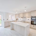 Modern kitchen with centre island and garden view.