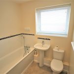 Compact bathroom with bath, sink, and toilet