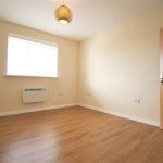 Minimalist empty room with wooden floor and window
