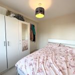 Cosy bedroom with wardrobe and floral bedspread