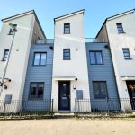 Modern terraced houses with blue and white facade.