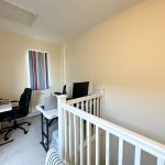 Home office with desk and chairs.
