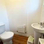 Small bathroom with toilet and sink.