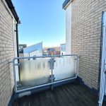 Small balcony with partial outdoor view.