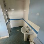 Accessible bathroom with shower and grab rails.