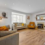 Cosy living room with modern decor and fireplace.