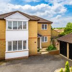 Two-storey brick house with attached garage.
