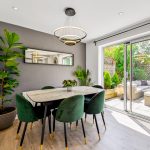 Modern dining room with access to sunny patio garden.