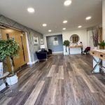 Modern lobby interior with wood flooring and decor.