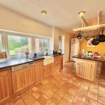 Spacious kitchen with island and large windows.