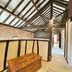 Rustic loft with exposed beams and chest.