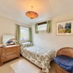 Cosy bedroom with single bed and vintage decor.