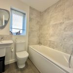 Modern bathroom with bathtub and sink.