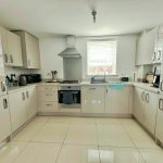 Modern kitchen with white cabinets and appliances