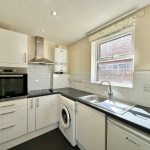 Modern kitchen interior with appliances and window