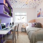 Cosy modern bedroom with desk and vibrant decor.