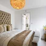 Luxurious bedroom with elegant decor and lighting.