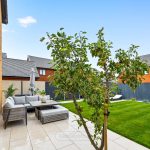 Modern garden with patio and seating area.