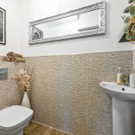 Modern bathroom with artwork and elegant decor.