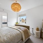 Elegant bedroom with stylish decor and large mirror.