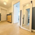 Modern hallway with mirror and wicker drawers