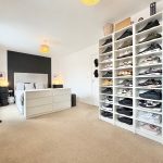 Modern bedroom with shoe storage display.