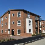 Modern red brick apartment building exterior view