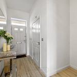 Bright hallway with mirror and decorative table
