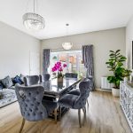 Modern dining room with grey chairs and table.