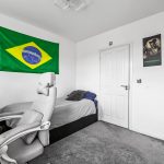 Bedroom with Brazilian flag and office chair