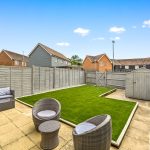 Modern garden with patio and seating area.