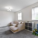 Bright living room with sofa and toys.