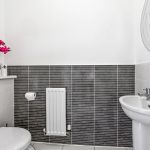 Modern bathroom with grey tiles and sink