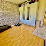 Empty bedroom with wardrobe and wooden flooring.