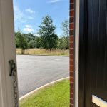 Open door revealing sunny outdoor scene