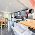Modern kitchen with dining area and island counter.