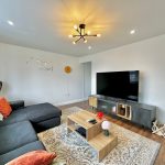 Modern living room with large TV and sofa