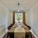 Elegant dining room with wooden table and decor.