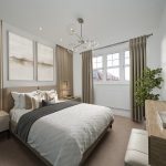 Modern bedroom with neutral decor and natural lighting.