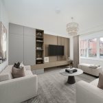 Modern living room with grey sofas and TV.