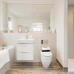 Modern bathroom with shower, bathtub, and vanity unit.