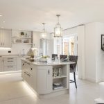 Modern kitchen with island and dining area.