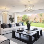 Modern living room with garden view and white sofas.