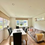 Bright dining and living area with garden view.